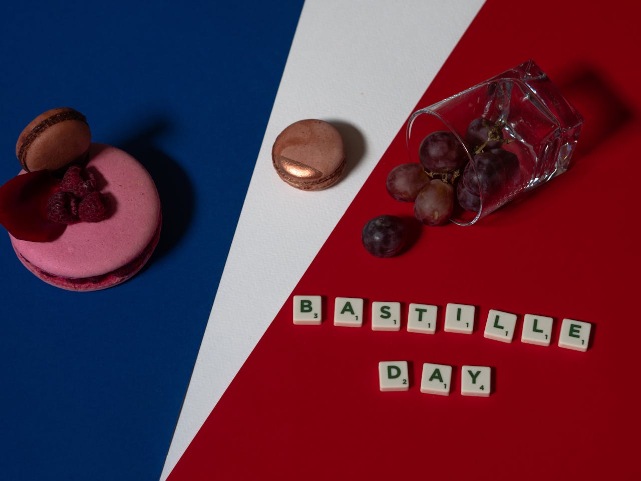 Bastille Day theme with French flag colors, macarons, grapes, and letter tiles creating a festive vibe.